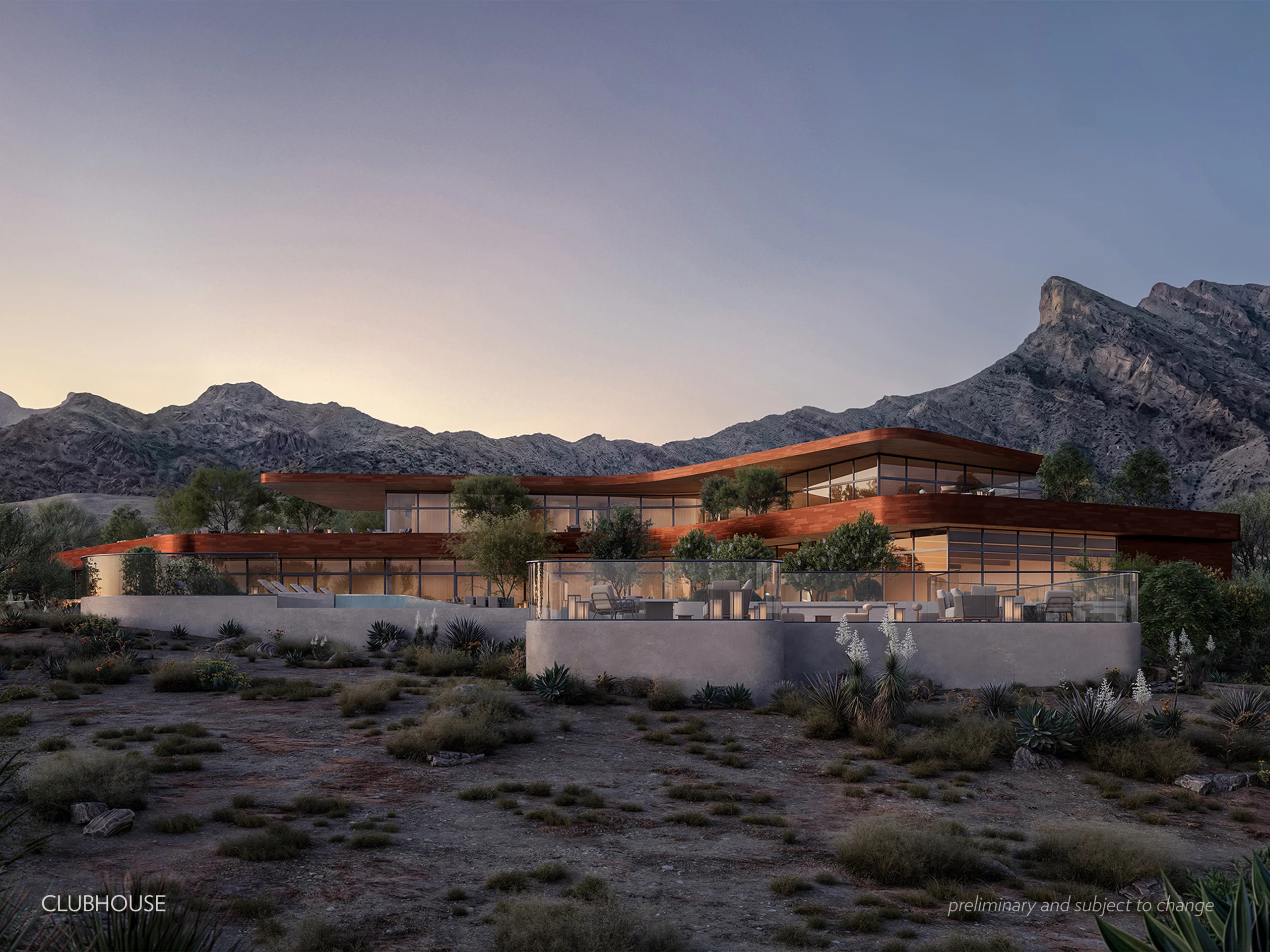 ClubHouse_w_Caption Modern, multi-level custom clubhouse with large glass windows and terraces, surrounded by desert vegetation and Nevada mountains in the background at dusk.